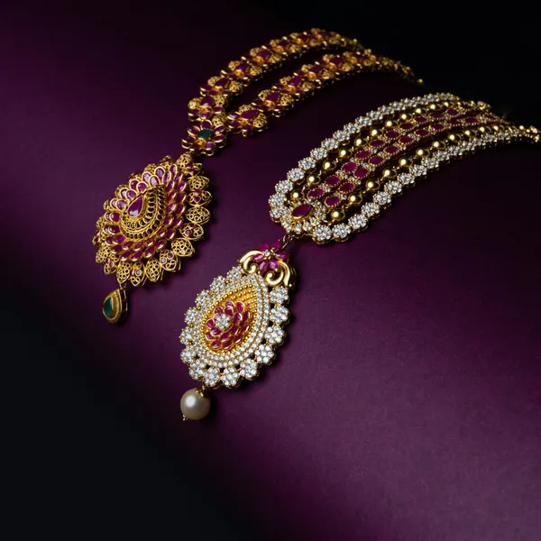 Gold maang tikka with pearl and pink stone drops
