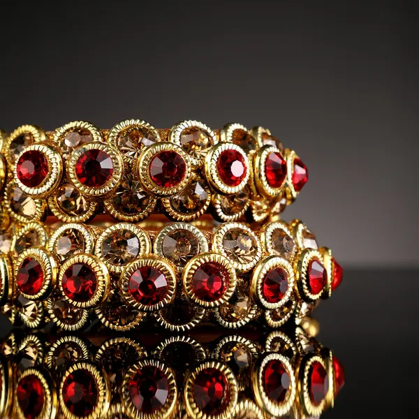A pair of gold-tone bangles set with round ruby stones